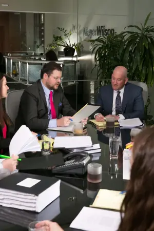 Meyer Wilson Werning staff gathered around conference table.