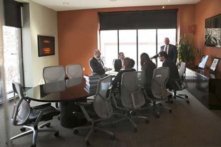 Meyer Wilson staff gathered around a conference table