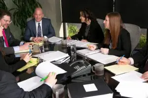 Dave Meyer and team discussion around conference table.