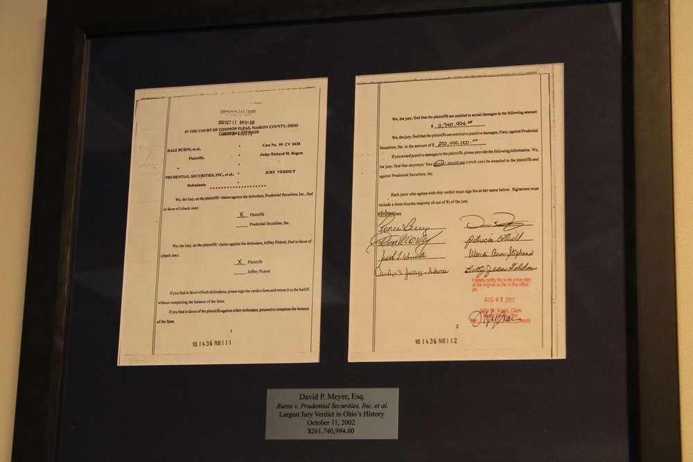 A legal verdict sits framed on a wall
