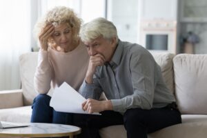 An upset couple learning of their investment fraud. A Newport Beach lawyer can help you get your money back after suffering losses due to investment fraud.