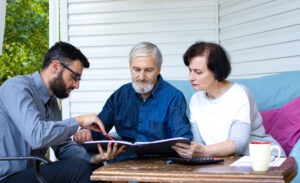 An investment fraud lawyer in Nashville speaking with an elderly couple.