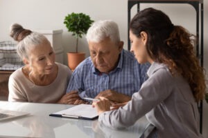 An investment fraud lawyer explaining Illinois securities fraud laws to her elderly clients.