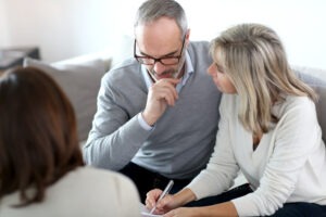 a mature couple meeting with a churning lawyer in Michigan