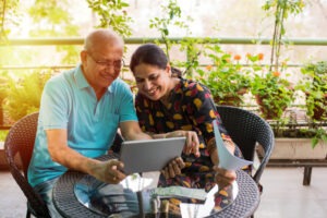 Senior investors with a laptop. It’s important to understand FINRA Rule 2330 - Deferred Variable Annuities and how it offers protections for investors.