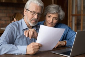 Senior investors with a laptop. It’s important to understand FINRA RULE 3241 and how it offers protections for senior investors.