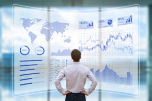 A financial professional examines a projection showing a detailed financial market analysis. An exchange traded note lawyer can explain more about what ETNs are backed by.