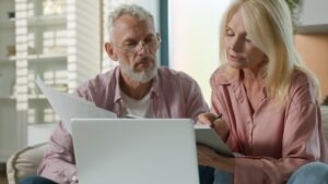 An older couple is researching online how to avoid life insurance fraud.