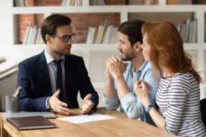 Lawyer explaining to two clients what are the damages for securities fraud