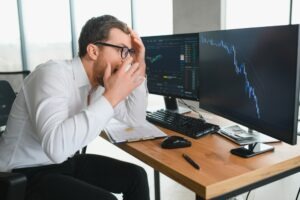Person looking at a computer screen with charts on it while looking concerned and wondering if they can file a lawsuit against Gemini.